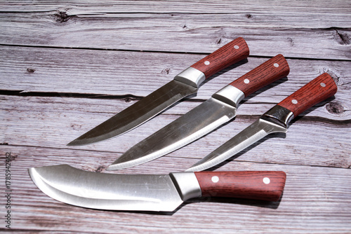 Kitchen knife on a wooden background. Knife with a blade of a wooden handle. Set of different knives