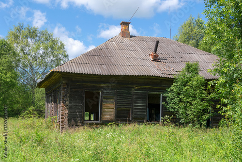 Ruins of an old abandoned wooden house in the countryside