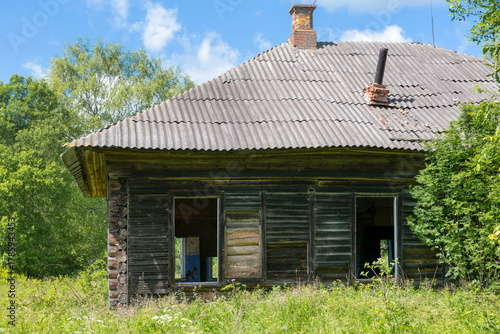 Ruins of an old abandoned wooden house in the countryside