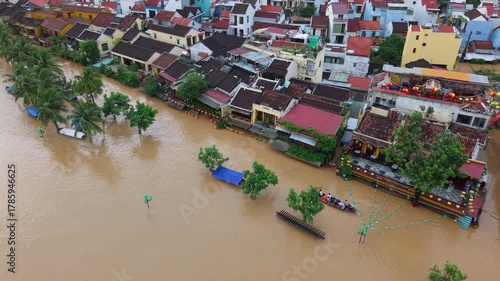 The deepest flood in history in Hoi An, Da Nang 2025. Aerial view of flooded ancient Asian town with yellow houses and brown roofs, showing severe urban flooding and climate disaster impact