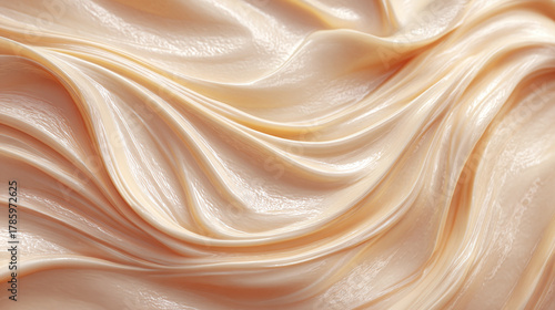 Close-up of a smooth, creamy texture with flowing waves and delicate shades of beige. The scene exudes elegance and smoothness
