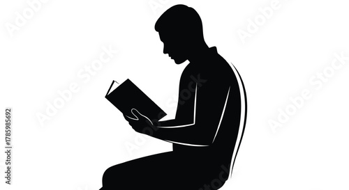 Silhouette of a young man sitting and reading a book with concentration and focus on a white background