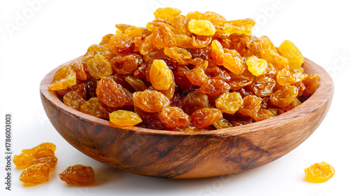 A wooden bowl of golden amber-colored dried raisins on a white background