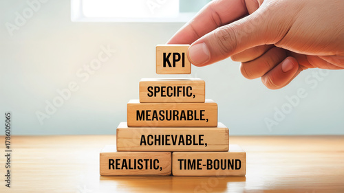 Wooden blocks stacked to form SMART goals and the placement of KPI block.