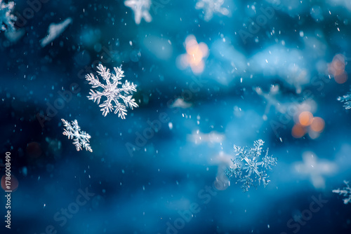 Close-up of snowflakes falling against a blurred winter background