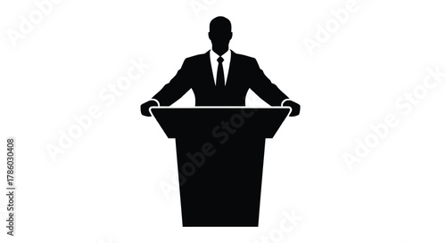 Silhouette of a man in a suit and tie standing behind a podium ready to speak or present