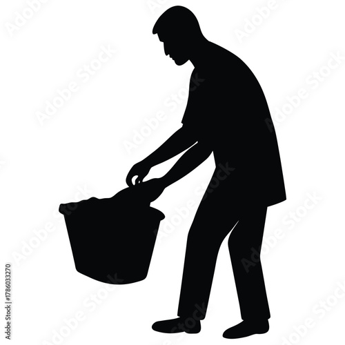 Man Silhouette Picking Up Laundry from Basket with Clothes in a Black and White Tone