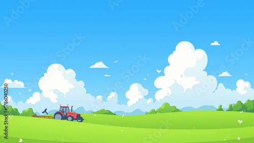 緑の丘を耕すトラクターのある田園風景