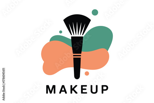 A black makeup brush is positioned centrally on a white background with abstract splashes of peach and teal colors behind it.