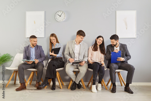 Behang Diverse office candidates sitting on chairs in row, business people applicants i