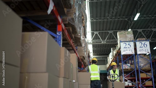 Blue collar workers are working at warehouse. Logistics, transportation.
