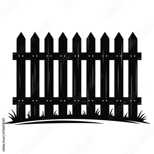 Rustic black wooden picket fence with grass silhouette