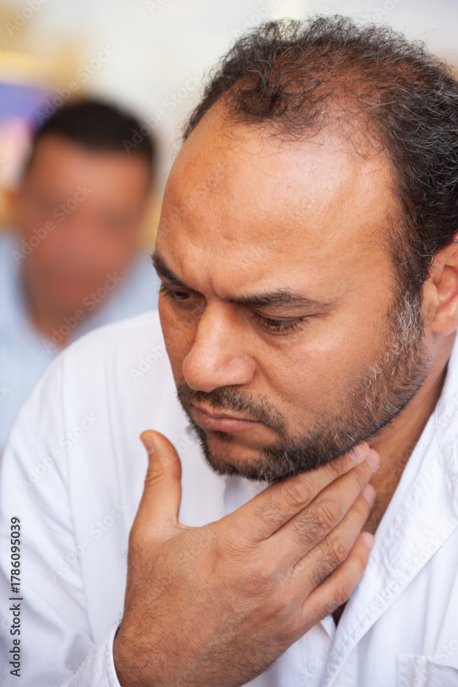 Obraz premium portrait of single Egyptian Arab man thinking, sited outdoors at a terrace