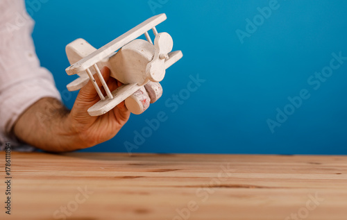 A hand holding a toy wooden...