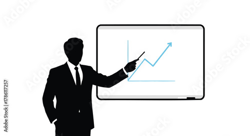 Silhouette of a businessman in a suit pointing at an upward trending graph on a whiteboard during a presentation