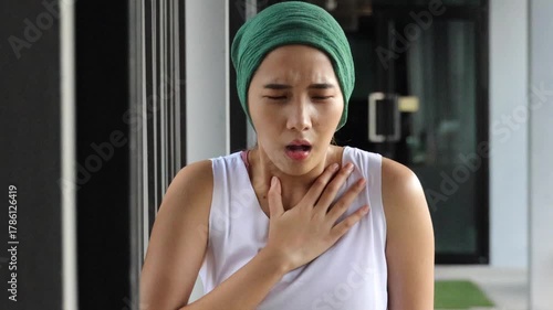 Asian woman cancer patient suffering from symptom relapse or negative side effect due to chemotherapy or radiation therapy breast cancer treatment