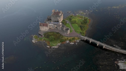 Aerial view of Eilean Donan Castle and lake Loch Duich in Scotland at sunrise