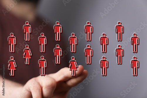 Hand holding figures repres...