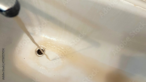Brown water flowing from the tap. Poor quality water.