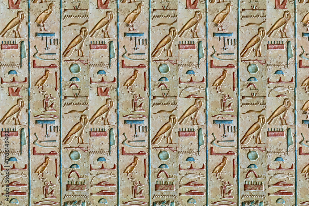 Obraz premium Hieroglyphic-inspired 3D mural with carved blocks arranged in repeating vertical patterns for a historical artistic finish. 