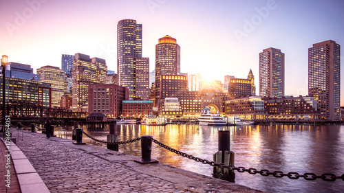 Boston Harbor and Financial District in Boston, Massachusetts, USA at sunset.