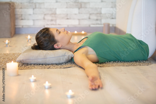 young caucasian woman doing yoga on sofa at home