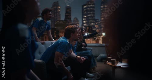 Friends Gather on a Rooftop to Watch a Championship Match. They Enjoy Sports and Entertainment Together, Cheering and Celebrating, Happy about Their Team Victory