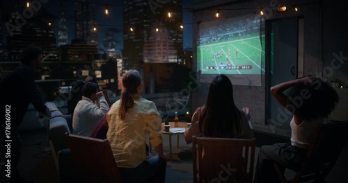 Friends Gather on a Rooftop, Watching Live American Football Match on a Projector. People Disappointed after their Team Loses.