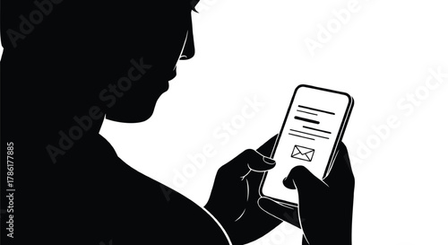 Silhouette of a person s head and shoulders as they hold a smartphone and interact with an email application on the screen