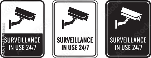 Three surveillance camera signs with the text surveillance in use 247 in black and white