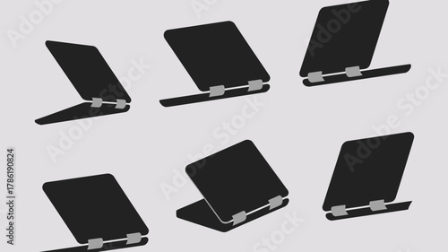 Sleek modern foldable laptops displayed in various dynamic angles on a clean neutral background, perfect for tech presentations and digital marketing.