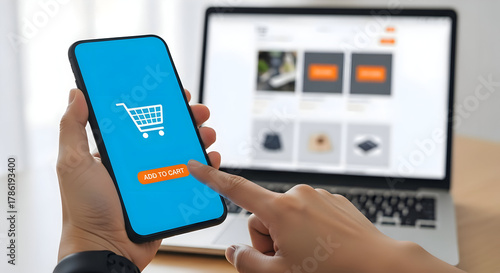 Seamless online shopping experience with a finger tapping 'Add to Cart' on a smartphone, laptop displaying e-commerce site in background