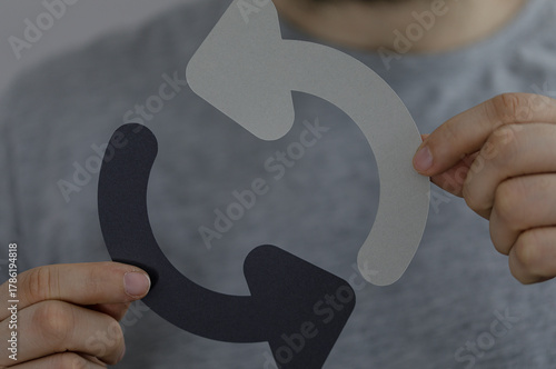 Person holding two arrow cu...