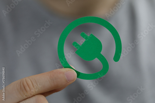 A hand holding a green elec...