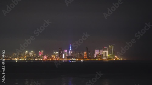 Timelapse of the dawn and the sunrise over the modern city skyline of Batumi, Georgia. Black Sea coast and iconic architecture as the city lights dim and the natural light of the morning brightens