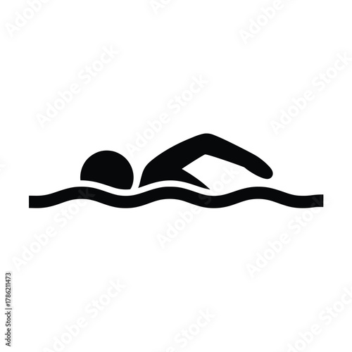 Black silhouette of a person swimming freestyle in wavy water