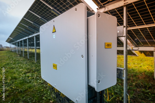 Wallpaper Mural solar inverter labeled 800V, installed under a ground-mounted solar panel array in a grassy field, used for energy conversion. Torontodigital.ca