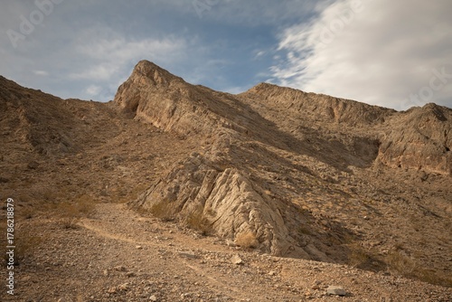 Rugged Desert Ridge under Shifting Clouds