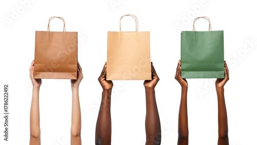 Diverse hands holding different eco-friendly paper shopping bags isolated on white background