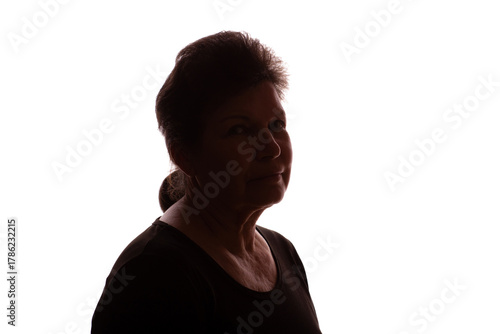 Dark silhouette of an elderly woman, pensioner, curly hair - isolate
