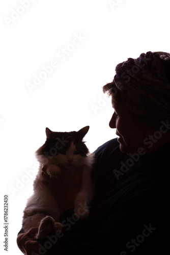 Dark silhouette elderly woman, pensioner with cat in hands - isolate