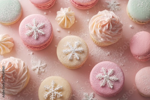 Festive array of colorful sweets decorated with snowflakes on a soft pink surface during winter celebration