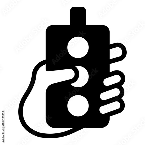 Wired remote with buttons in hand solid icon, manufacturing concept, control process sign on white background, glyph style for mobile web design. Vector graphics.