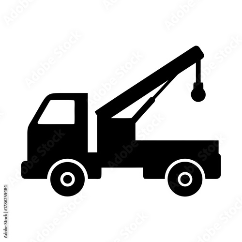 Black silhouette of a tow truck with crane arm