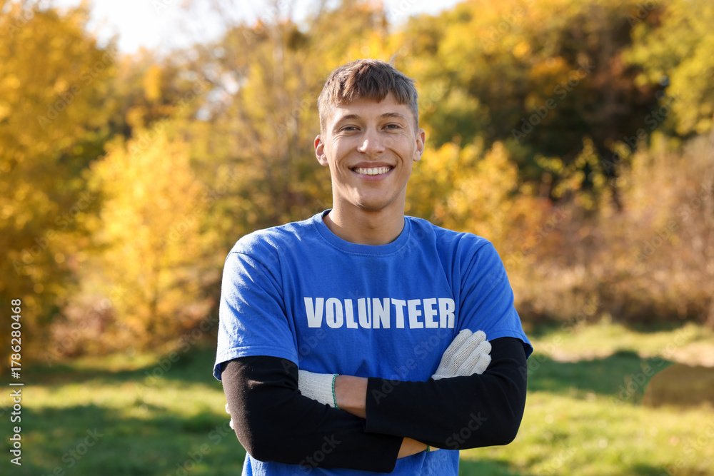 Fototapeta premium Environment protection. Happy young volunteer in park