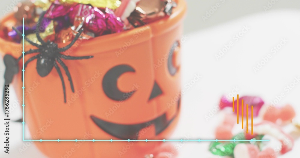 Naklejka premium Sitting orange pumpkin bucket filling with candy on white table, spider, teal line and orange bars