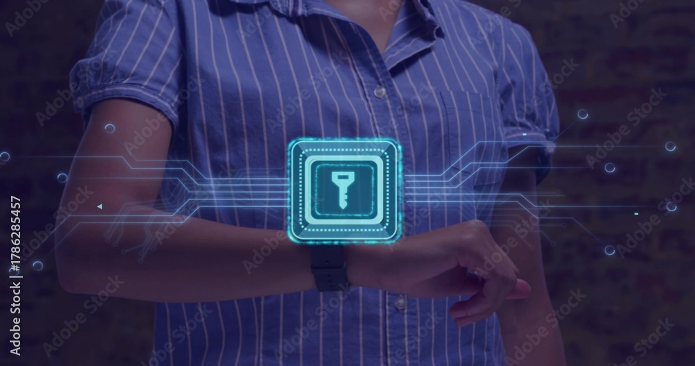 Fototapeta premium Extending female torso and arms wearing blue striped shirt in studio, using smartwatch holo key UI