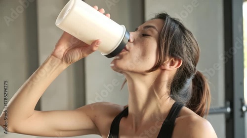 Female Athlete Drinking a Fat Burner Shake Before a Workout