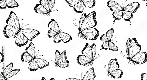 Elegant pattern of detailed black and white butterflies in flight, set against a white background, perfect for nature and decorative themes.