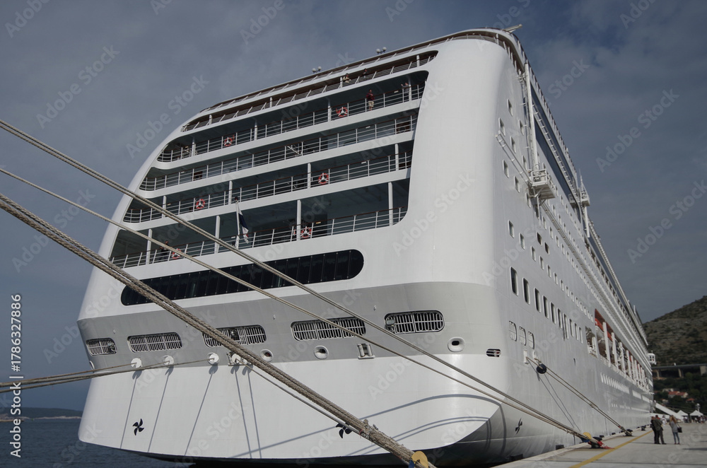 Naklejka premium Italian family cruiseship cruise ship liner Lirica, Armonia or Sinfonia in port of Dubrovnik, Croatia during Summer Mediterranean cruising with harbor infrastructure marine traffic